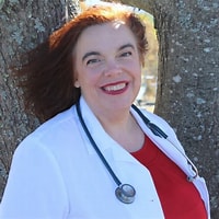 Photo of Stephanie Chin standing by a tree and smiling